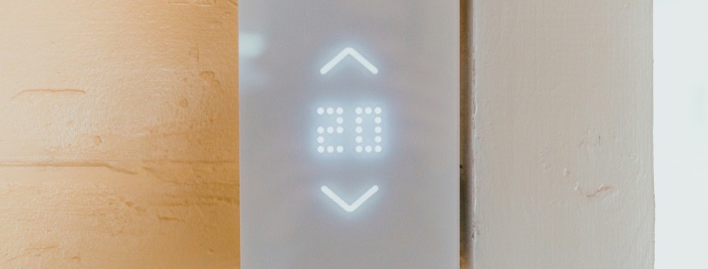 Wall thermostat displaying the room temperature
